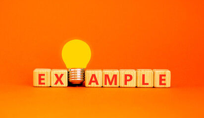 Example examples symbol. Concept word Example on beautiful wooden blocks. Beautiful orange...