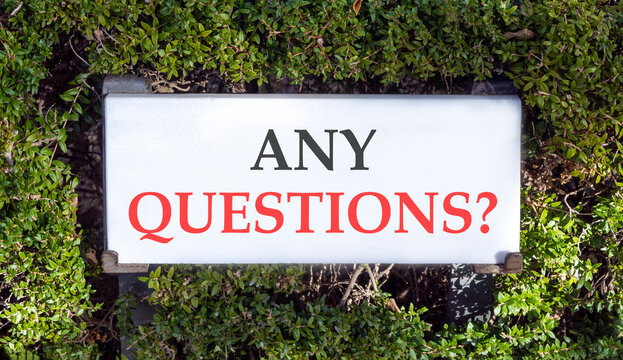 Any questions symbol. Concept words Any questions on beautiful big white sign plate. Beautiful green garden background. Business and Any questions Q and A concept, copy space.