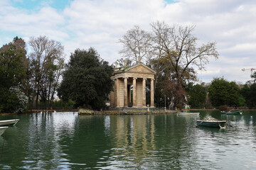 Iconic pavilion reflected in water at Rome park. Tourism and Italian city landscape view. © Olga