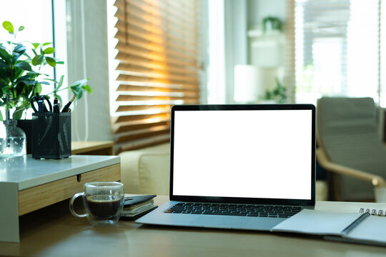 Empty laptop screen, desktop organizer with desk shelves and office supplies. Back to school, home office, begining of studies concept. Mockup, template