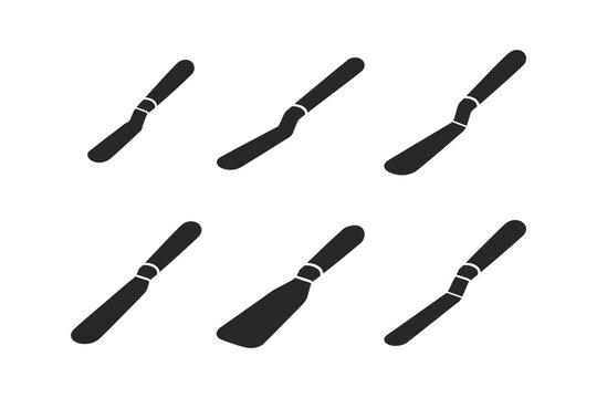 Set of six black palette knives and spatulas on a white background