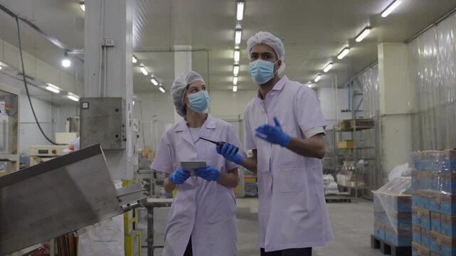 Collaboration in food processing industry factory training session cleanroom environment side view teamwork success