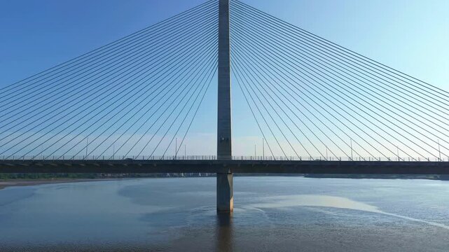 Liverpool, Merseyside, UK, June 19, 2025; Aerial 4K video footage of the Mersey Gateway toll bridge with stunning views over the River Mersey, Liverpool, UK.