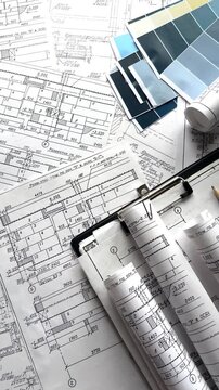 Architecture blueprints with rolled plans, compass and clipboard on desk, construction documentation and engineering design workflow, BIM planning and project management concept, copy space.