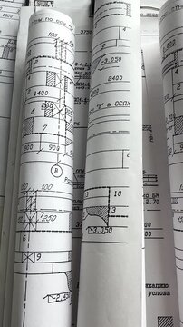 Architecture blueprints with rolled plans, compass and clipboard on desk, construction documentation and engineering design workflow, BIM planning and project management concept, copy space.