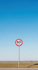 Speed Limit Sign Under A Vivid Blue Sky Indicating Sixty Kilometers Per Hour on the Road