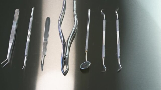 Dental instruments laid out on a table for extracting teeth, forceps