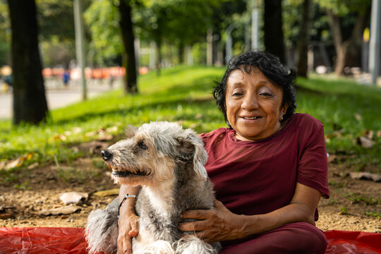 woman with osteogenesis imperfecta and dwarfism in a public park with her dog