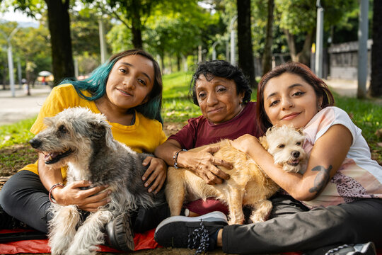 Small group of women with osteogenesis imperfecta and dwarfism in a public park with their dogs
