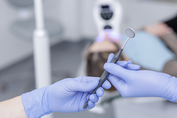 Dentist holding dental mirror before whitening procedure