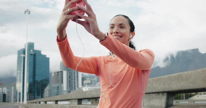 Earphones, runner and woman with selfie on city road, post workout picture and social media update. Photography, tech and athlete with smile for complete training, sports vlog and fitness influencer