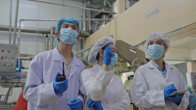 Laboratory team conducts quality control inspections food production facility action shots industrial environment team collaboration safety protocols