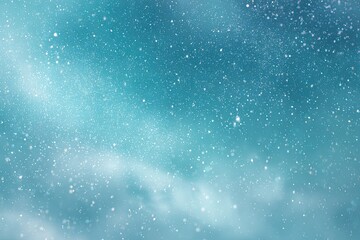 Fototapeta premium Abstract image of a blue and teal gradient speckled with glittering particles; evokes space
