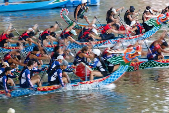 Scene of a competitive boat racing in the Dragon Boat Festival in Taipei, Taiwan, where the athletes pull vigorously on the oars compete with all their strength in traditional colorful dragon boats