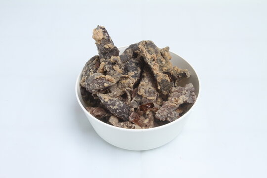 a bowl of keripik paru on white background