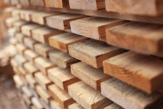 Close-up of the boards. The texture of the wood. Lumber warehouse. Wooden pallets. Natural wood. Wooden pallets for transportation of building materials. Pallets made of renewable wood.