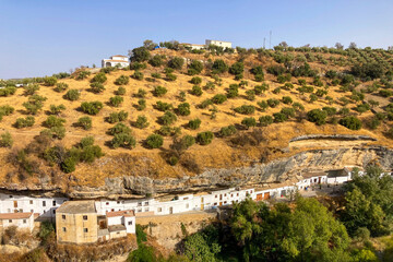 Unique whitewashed village built into dramatic rock formations, offers one of Andalusia&rsquo;s most picturesque sights in Setenil de las Bodegas, Spain