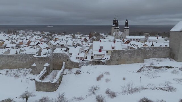 Drone Flight Over Visby Ringmuren Revealing Snowy Old Town, Cathedral and Ferry in the Baltic Sea, Gotland Sweden
