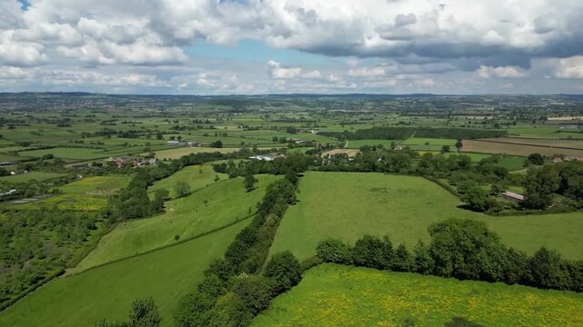 Wide Aerial View of Somerset Levels Countryside with Blue Sky and Cumulus Clouds England UK