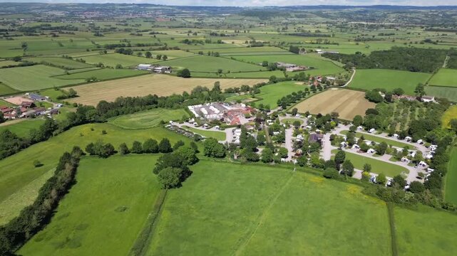 Wide Aerial Panorama of Somerset Countryside with Village and Patchwork Fields Near Glastonbury England