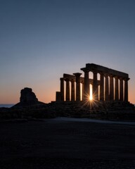 Obraz premium Ancient Roman temple ruins featuring stone columns silhouetted against a vibrant sunset sky for Mediterranean travel and historical heritage site tourism background
