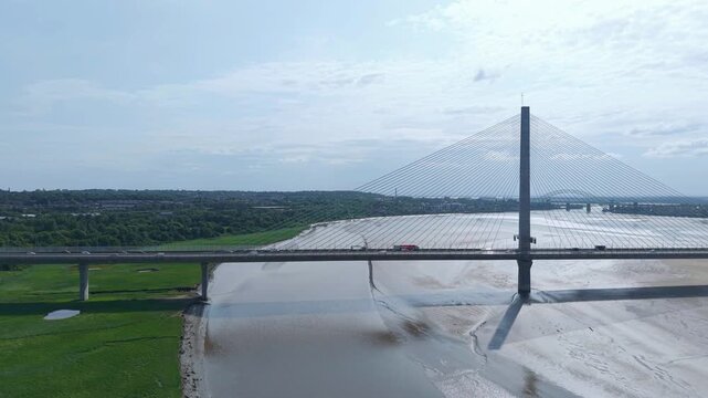 Liverpool, Merseyside, UK, June 19, 2025; Aerial 4K video footage of the Mersey Gateway toll bridge with stunning views over the River Mersey, Liverpool, UK.