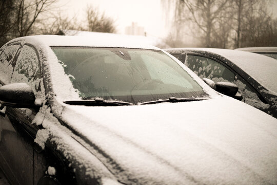 Heated glass on a modern snow-covered car. High quality photo