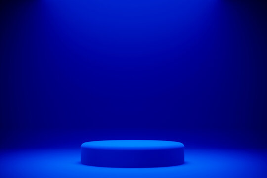 Empty blue cylindrical podium on clean infinite blue studio background