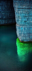 stunning blue rock formation with green water reflection