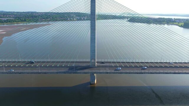 Liverpool, Merseyside, UK, June 19, 2025; Aerial 4K video footage of the Mersey Gateway toll bridge with stunning views over the River Mersey, Liverpool, UK.