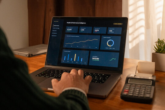 Wealth management dashboard on laptop showing portfolio performance and financial reporting analysis