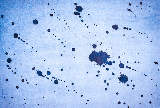 Ink splash over vintage paper, blue watercolour splatter background.