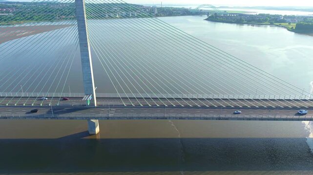 Liverpool, Merseyside, UK, June 19, 2025; Aerial 4K video footage of the Mersey Gateway toll bridge with stunning views over the River Mersey, Liverpool, UK.