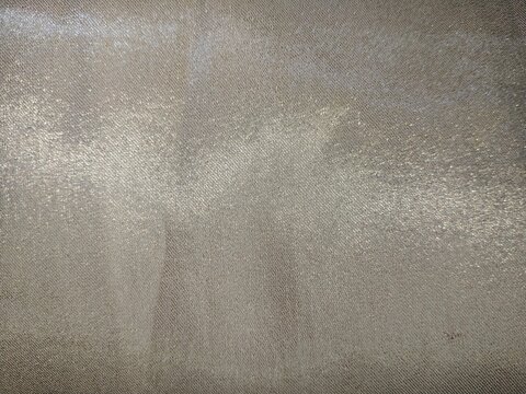 Closeup view of a light colored fabric texture with a slight sheen