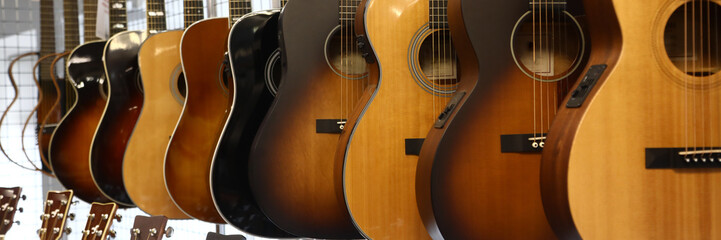 Obraz premium Acoustic guitars hanging in a store