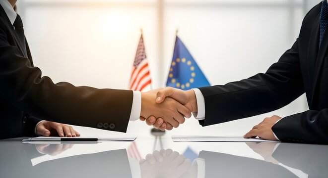 Two diplomats shaking hands across a meeting table with United States and European Union flags in the background, representing international trade agreements and geopolitical strategy.