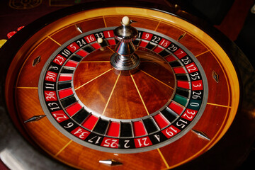 Casino theme, betting, online casino. image of red color casino roulette, poker game. roulette wheel. online casino, bets, winnings. Luxury roulette. close-up image