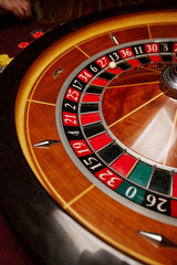 Casino theme, betting, online casino. image of red color casino roulette, poker game. roulette wheel. online casino, bets, winnings. Luxury roulette. close-up image