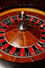 Casino theme, betting, online casino. image of red color casino roulette, poker game. roulette wheel. online casino, bets, winnings. Luxury roulette. close-up image