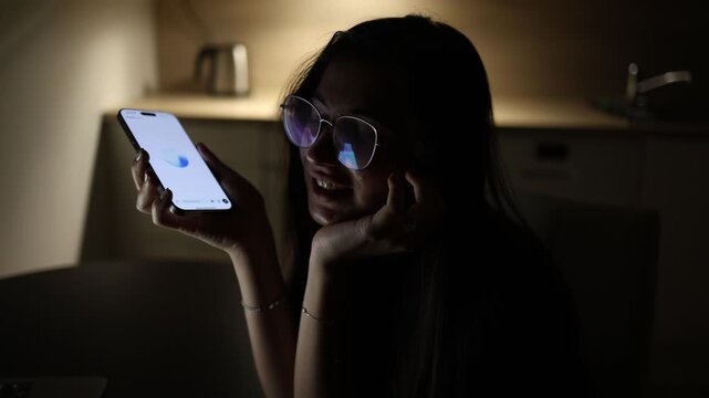 Schoolgirl at home at night using smartphone asking questions to chatgpt about studies and life situations ai assistant helping