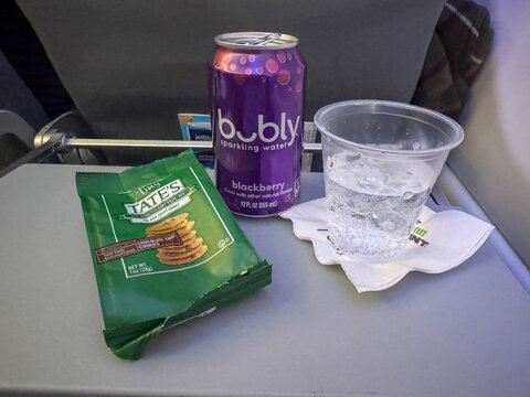 An Open Can of bubly Blackberry Sparkling Water, a Bag of Tate's Tiny Chocolate Chip Cookies