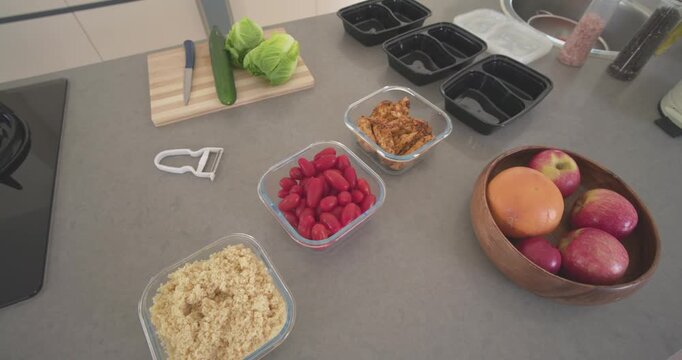 Camera is starting to pan and tilt on counter showing cutting board with knife and grains