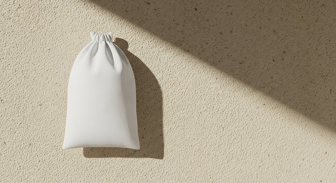 White cotton pouch on textured beige surface with diagonal video game character