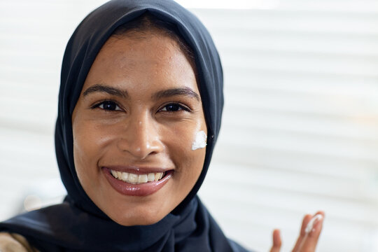 Community members co-designing mural honoring Indigenous resilience on school wall with QR code