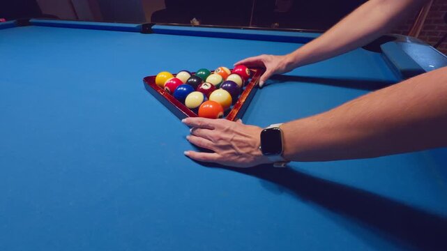 Woman Adjusting Triangle Rack With Pool Balls On Blue Table Preparing For Opening Break
