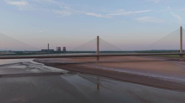 Liverpool, Merseyside, UK, June 19, 2025; Aerial 4K video footage of the Mersey Gateway toll bridge with stunning views over the River Mersey, Liverpool, UK.