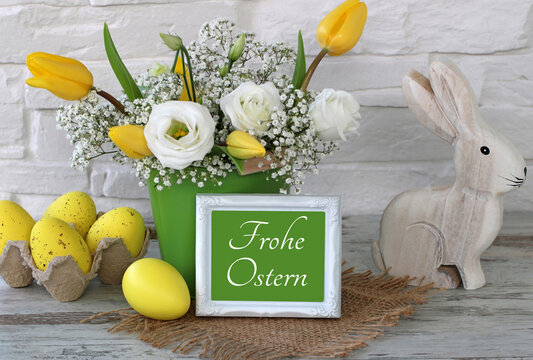 Gru&szlig;karte Frohe Ostern: Osterhase  mit Ostereiern Blumen und der Text Frohe Ostern.	