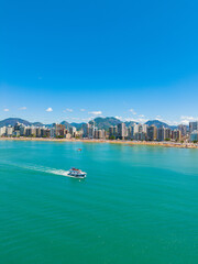 Aerial view of crowded Praia do Morro beach during summer tourism season in Guarapari Brazil