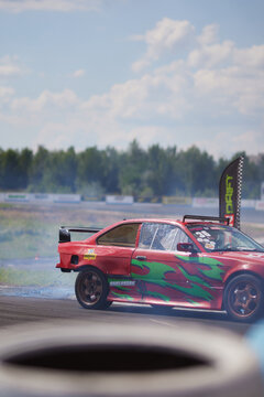 Kyiv, Ukraine, Chaika Raceway - August 3, 2023: Drift car in a race with smoke. Drift car close-up. Drift cars and drivers, street racing, auto culture. Drift culture.