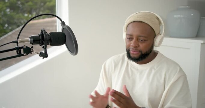 Man adjusting mic pop-filter mount lifting headset preparing to record in home studio, copy space